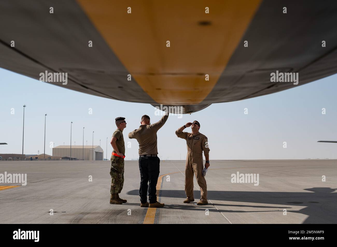 U.S. Air Force Airmen conduct preflight inspections on a U.S. Air Force KC-135 Stratotanker assigned to the 28th Expeditionary Air Refueling Squadron at Al Udeid Air Base, Qatar, Feb. 26, 2022. The 28th EARS, deployed with U.S. Air Forces Central Command, is responsible for delivering fuel to U.S. and coalition forces, enabling war-winning air power, deterrence and stability to the region. Stock Photo