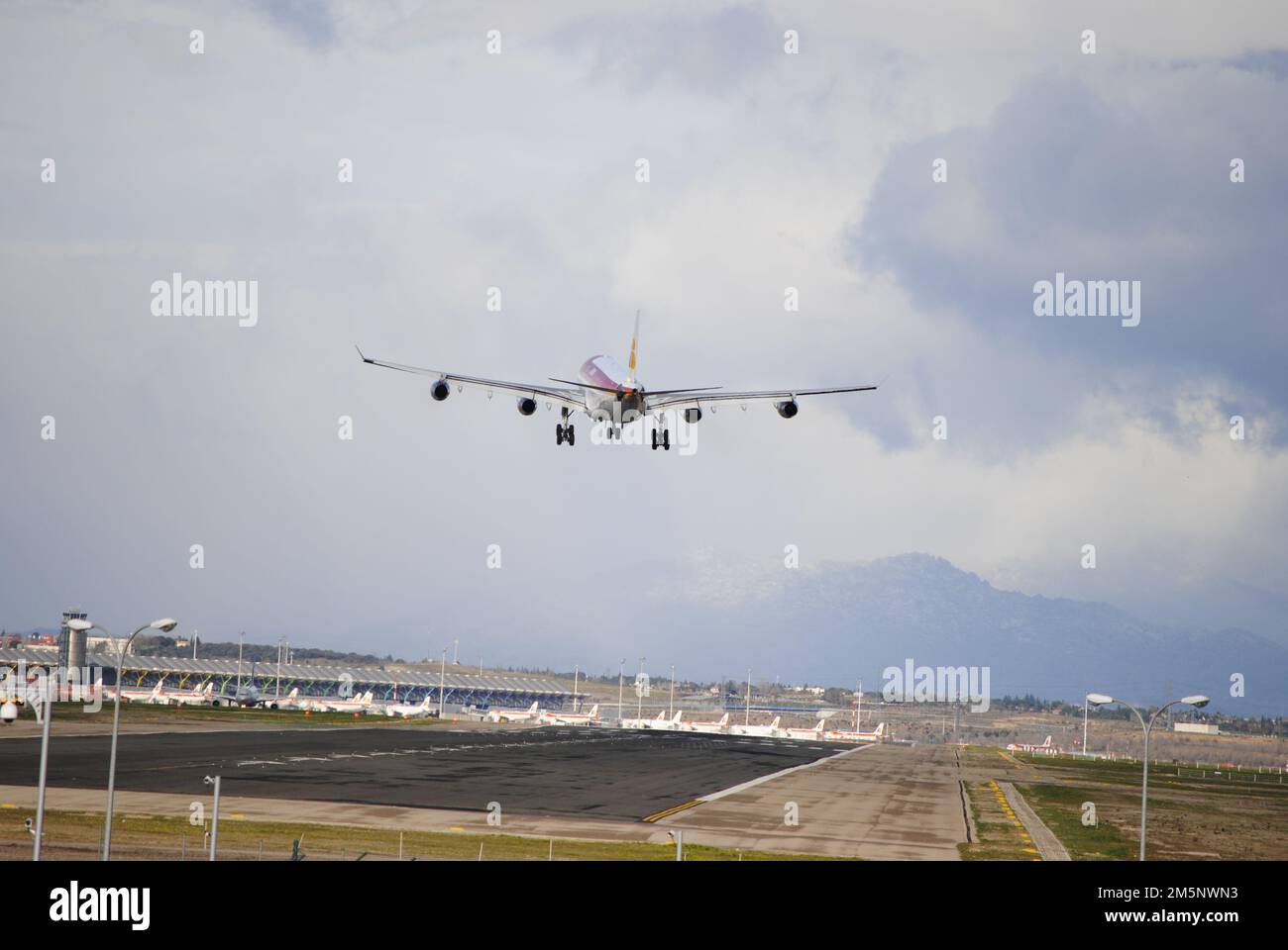 An aircraft plane taking off and flying over the Airport Runway under ...