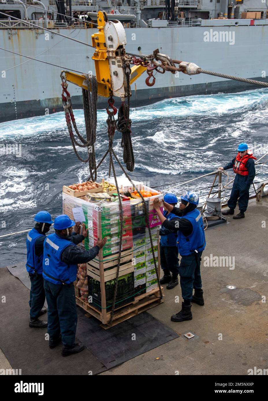 220226-N-HG846-1070 ADRIATIC SEA (Feb. 26, 2022) Sailors aboard Arleigh Burke-class guided-missile destroyer USS Mitscher (DDG 57) receive stores during a replenishment-at-sea with the Supply-class fast combat support ship USNS Supply (T-AOE-6), Feb. 26, 2022. Mitscher is deployed with the Harry S. Truman Carrier Strike Group on a scheduled deployment in the U.S. Sixth Fleet area of operations in support of U.S., allied and partner interests in Europe and Africa. Stock Photo