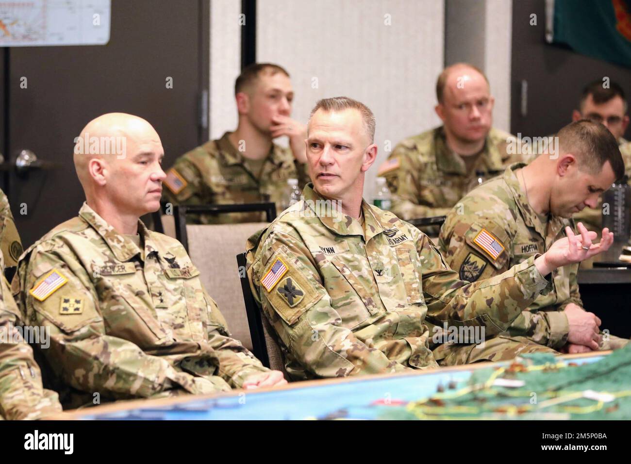 U.S. Army Maj. Gen. Thomas Spencer, commander of the 42nd Infantry Division, New York Army National Guard and Col. Sean Flynn, Commander of the 27th Infantry Brigade Combat Team, New York Army National Guard, discuss the theoretical applicaiton of multi-domain operations in a modern-day version of the Battle of Saipain in World War II during a leaders workshop in Syracuse, New York, February 26, 2022. The workshop served to prepare the 27th IBCT's senior leaders for upcoming deployments and development of their future forces. Stock Photo