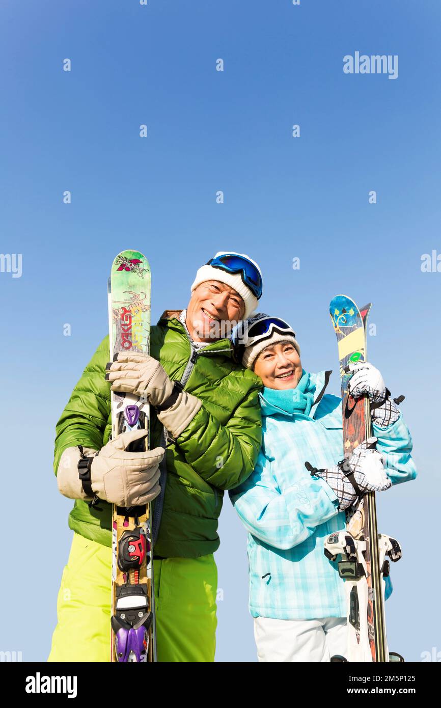 Elderly couple winter skiing Stock Photo