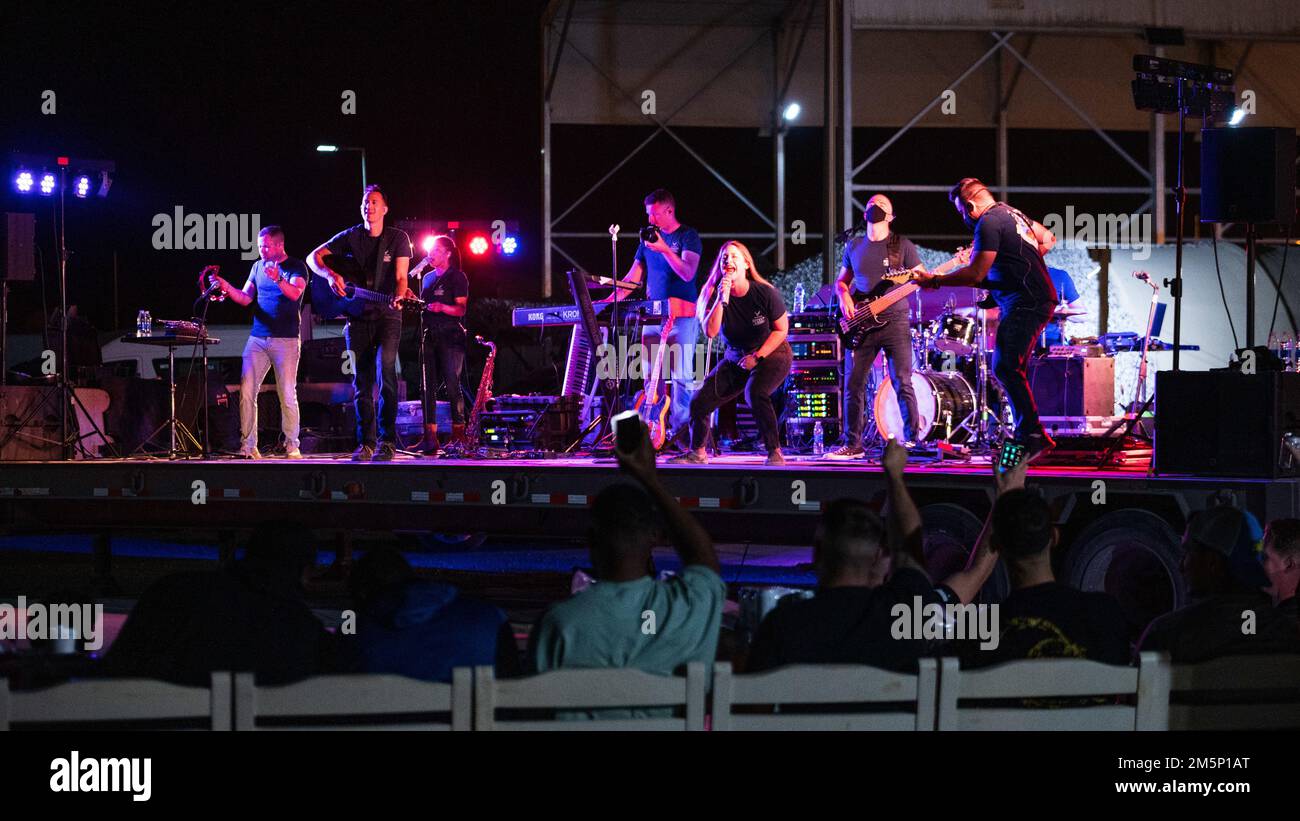 Members of the U.S. Air Forces Central Band perform a concert at Prince Sultan Air Base, Kingdom of Saudi Arabia, Feb. 26, 2022. During their time at PSAB the band performed multiple concerts including a country show, a rock show and a live band karaoke show. Stock Photo