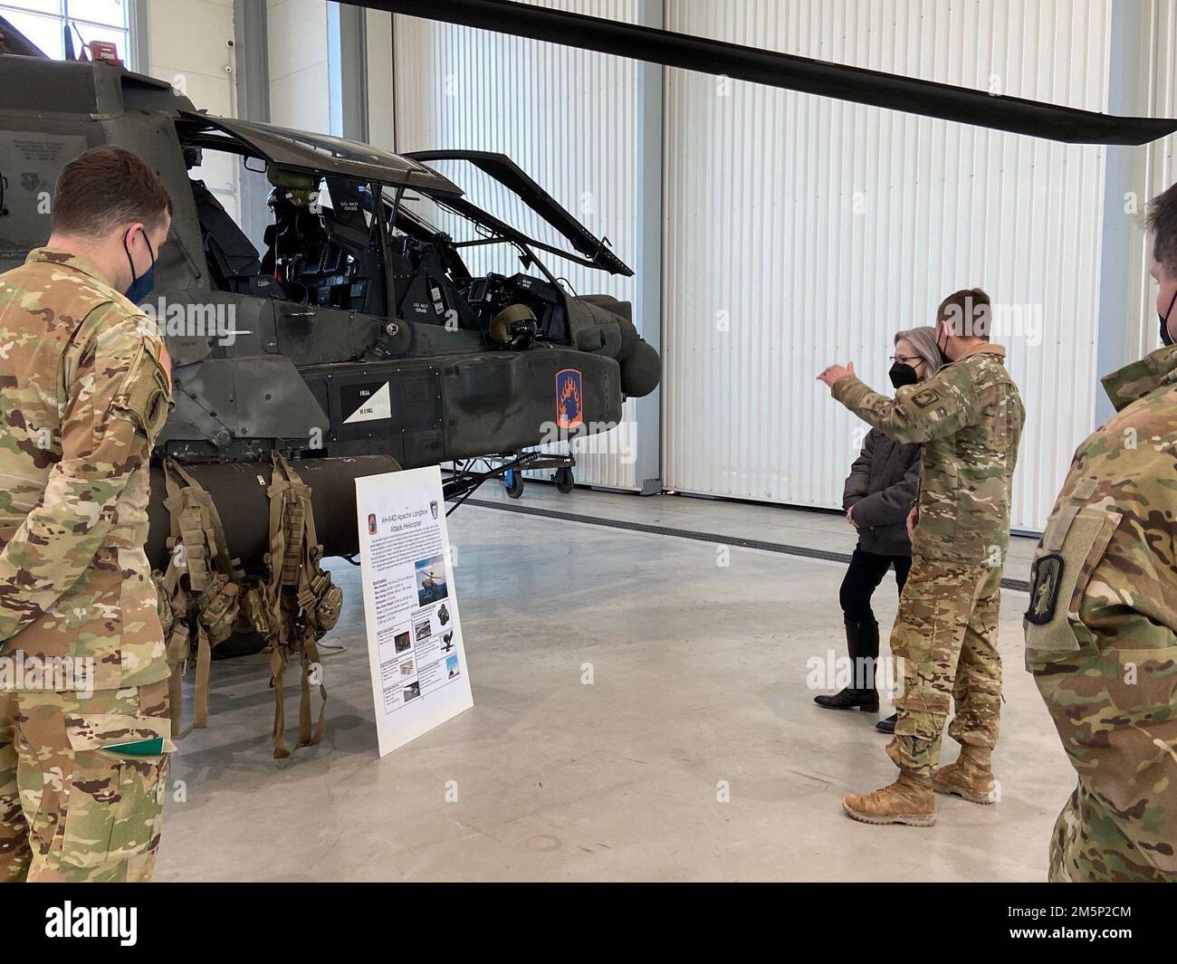 Chief Warrant Officer 2 Justin Schriener, 152B Apache Pilot, Bravo Company 1-3rd Attack Battalion, provides an AH-64D capabilities brief to Ruta Elvikis, Deputy Chief of Mission, U.S. Embassy Riga during her visit on 27 February 2022. (U.S. Army Photo: 1LT Lisabeth Quinn) Stock Photo