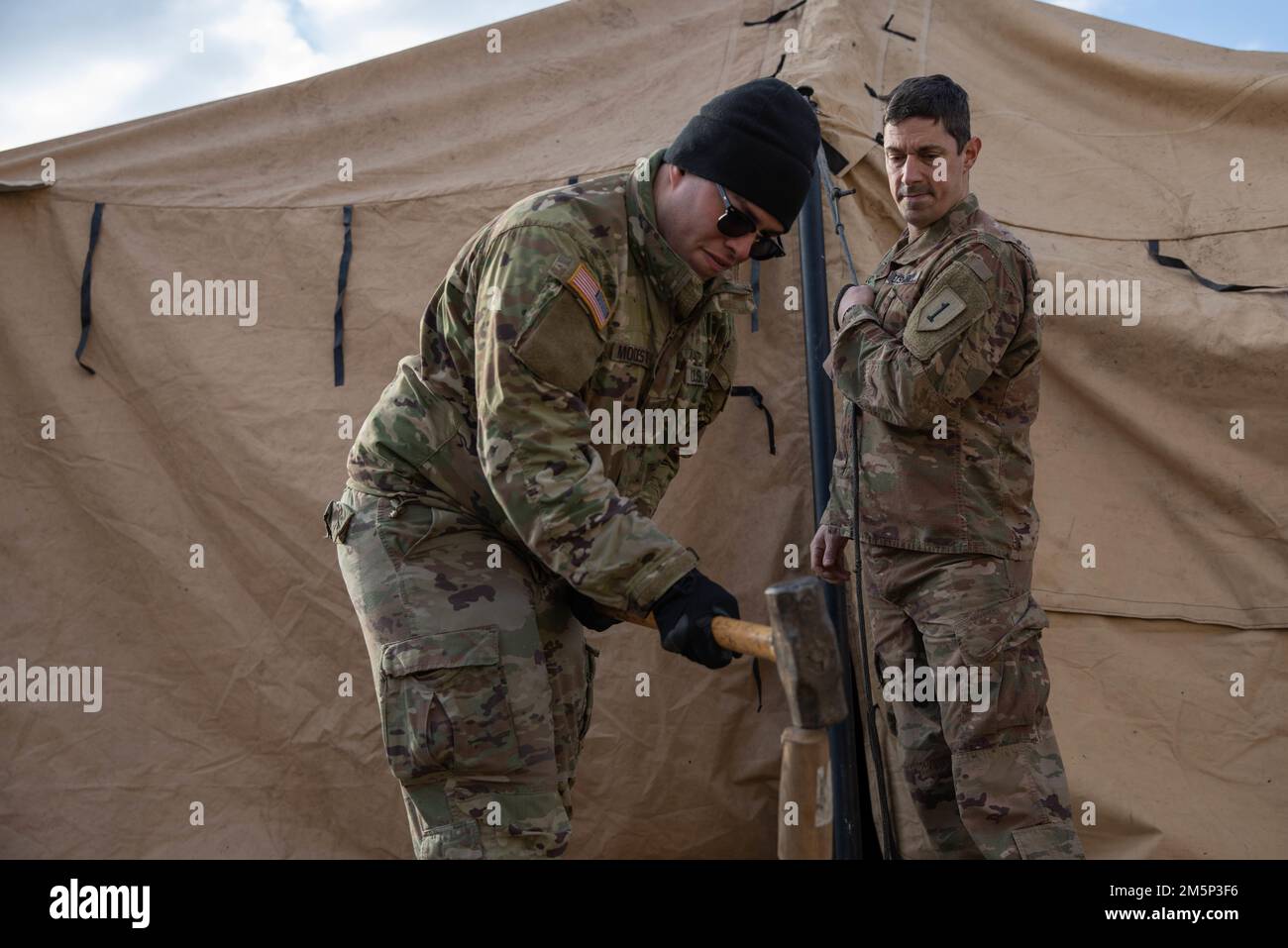 Capt. Scott Leduc, a physician’s assistant, and Spc. Pedro Modesto, a combat medic, both of whom are assigned to 2nd Battalion, 34th Armored Regiment, 1st Armored Brigade Combat Team, 1st Infantry Division, set up an aid station tent, Feb. 27, at Hradiště Military Area in Northwest Czech Republic. The 2/34th is preparing for two weeks of rigorous training as part of Saber Strike 22, a large scale, multi-national exercise taking place throughout Europe to enhance readiness and relationships between NATO allies in the U.S. Army Europe region. Stock Photo