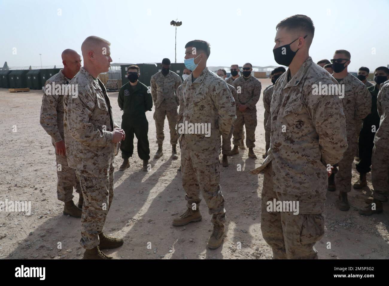 U.S. Marine Corps Maj. Gen. Paul Rock, Commander, U.S. Marine Corps Forces Central Command recognizes two Marines from Marine Fighter Attack Squadron 115 (VMFA-115) for their hard work and performance while being deployed to Prince Sultan Air Base, Kingdom of Saudi Arabia, during his visit to Prince Sultan Air Base, Kingdom of Saudi Arabia on Feb. 27, 2022. VMFA-115 has been deployed to Prince Sultan Air Base in the Kingdom of Saudi Arabia since December 2021 and are an integral part of the Immediate Response Force in the Central Command area of responsibility. Stock Photo