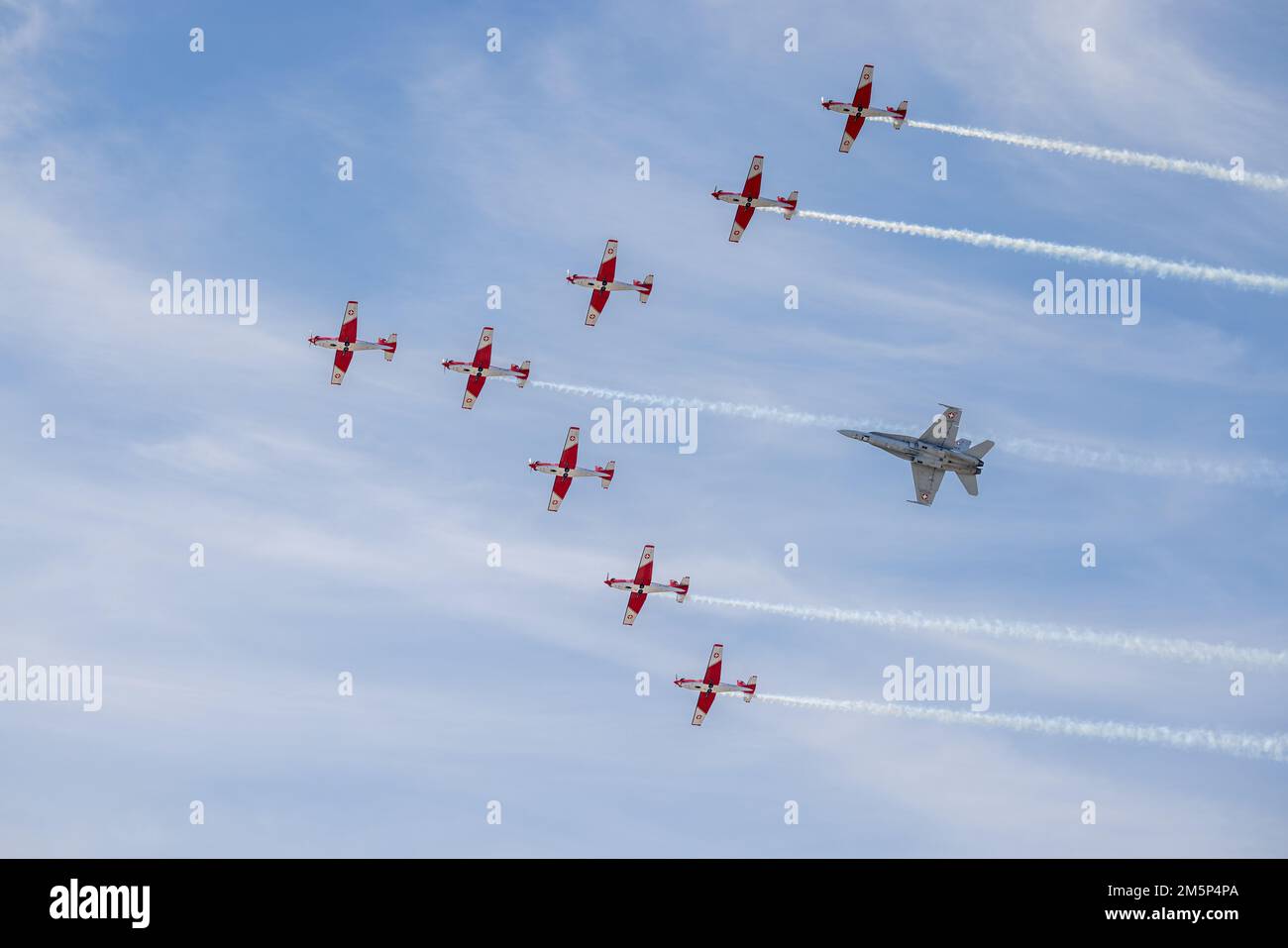 Swiss Air Force PC-7 aerobatic display team flying in formation with a Swiss F/A-18C Hornet at the 2022 Royal International Air Tattoo Stock Photo