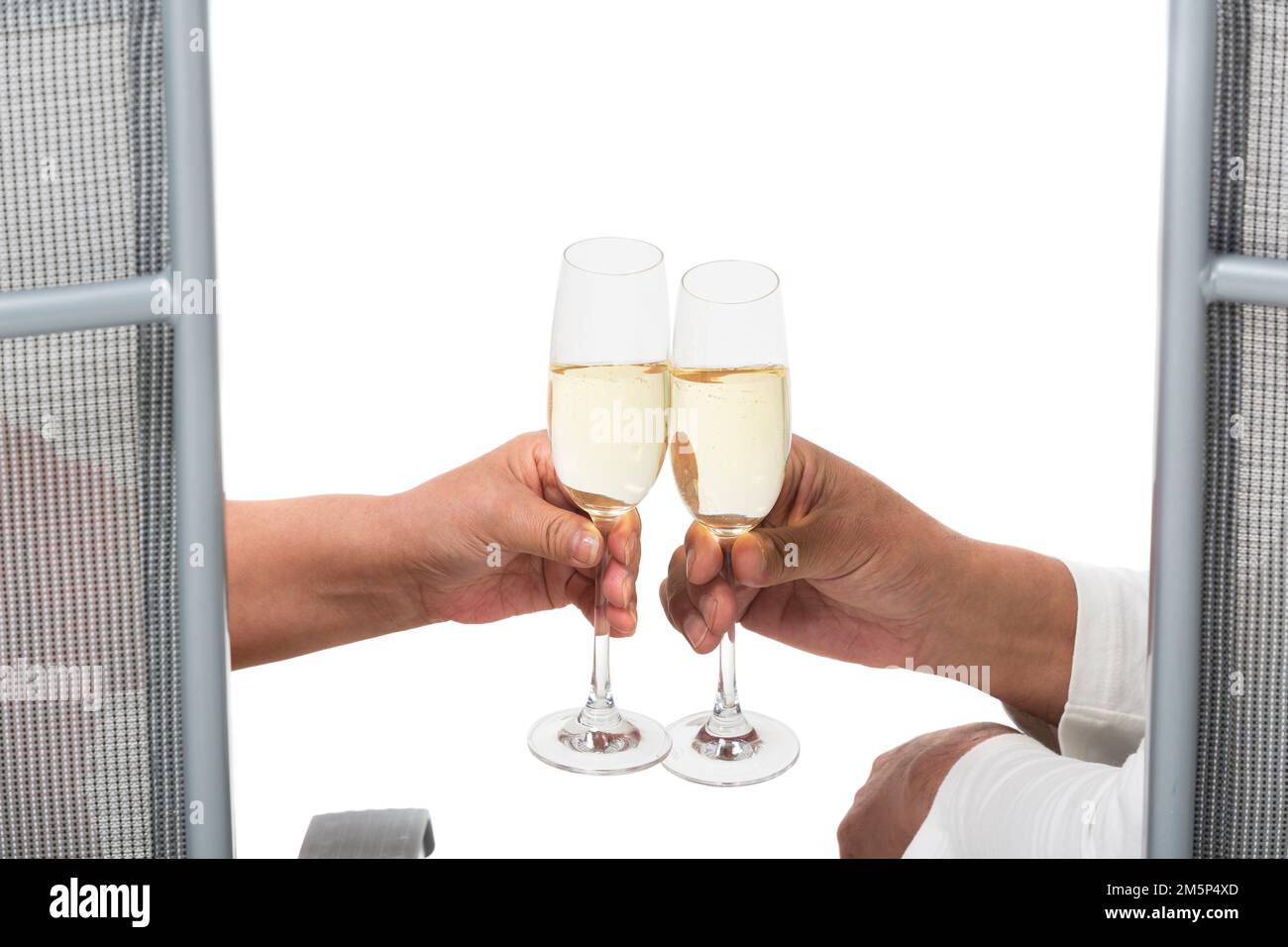 Happy elderly couple sitting on a beach chair drink champagne Stock Photo