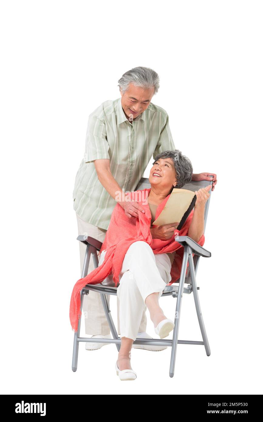 Happy elderly couple sitting on a beach chair Stock Photo