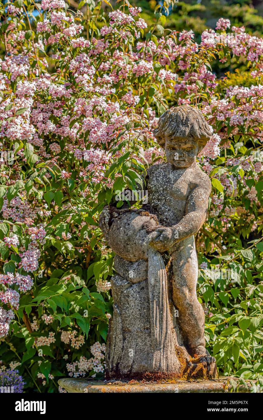 Putto Figure at the Queens garden of Sudeley Castle, Winchcombe, Gloucestershire, England Stock Photo