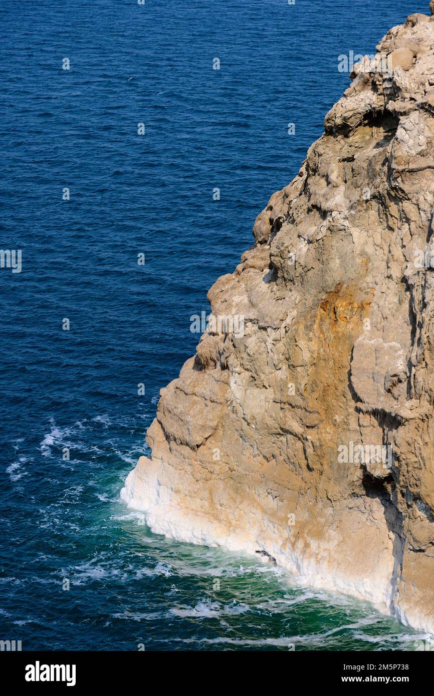 Dead Sea Water and Rock Cliff with Salt Crystals showing Evaporation