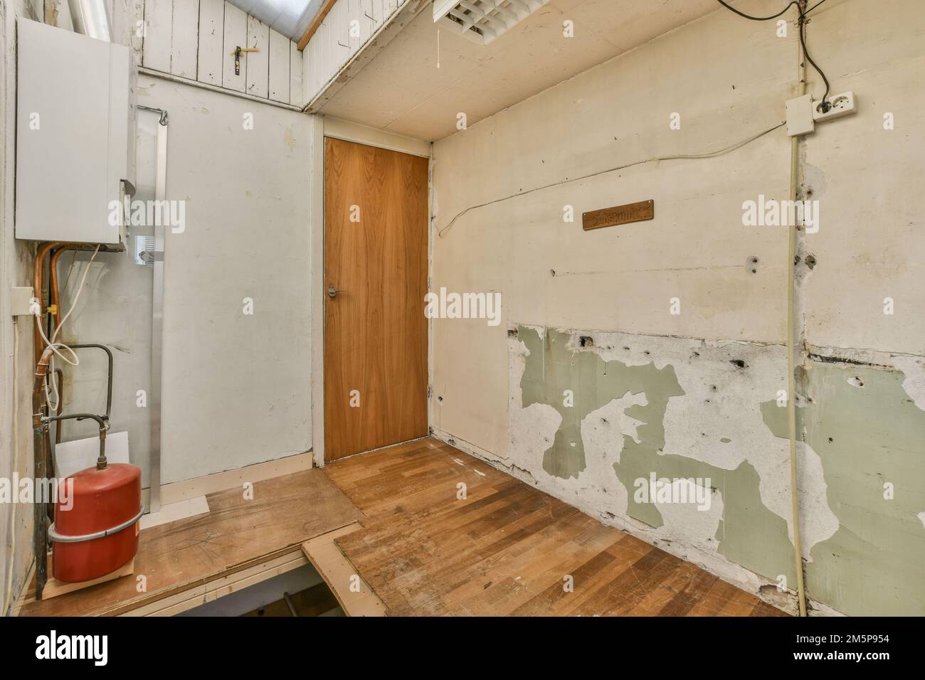 an unfinished room with wood flooring and white paint on the walls, in