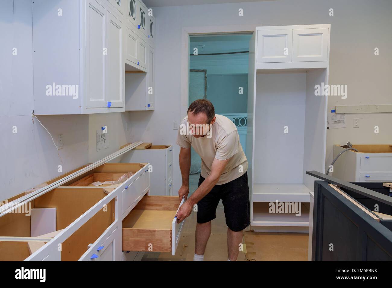 Working on kitchen draw in new home by carpenter Stock Photo
