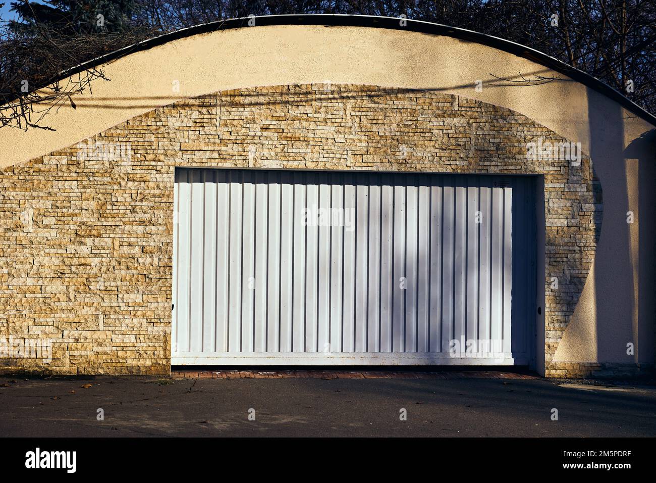 White automatic garage doors opening horizontally Stock Photo Alamy