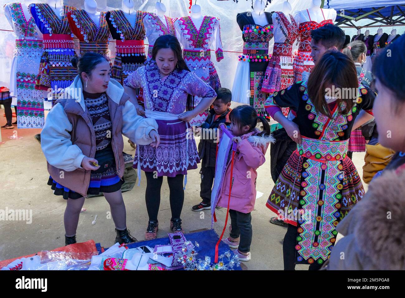 Can Cau, Vietnam - December 17, 2022: A clothing seller in the Can Cau market in Lao Cai province, Vietnam. Stock Photo