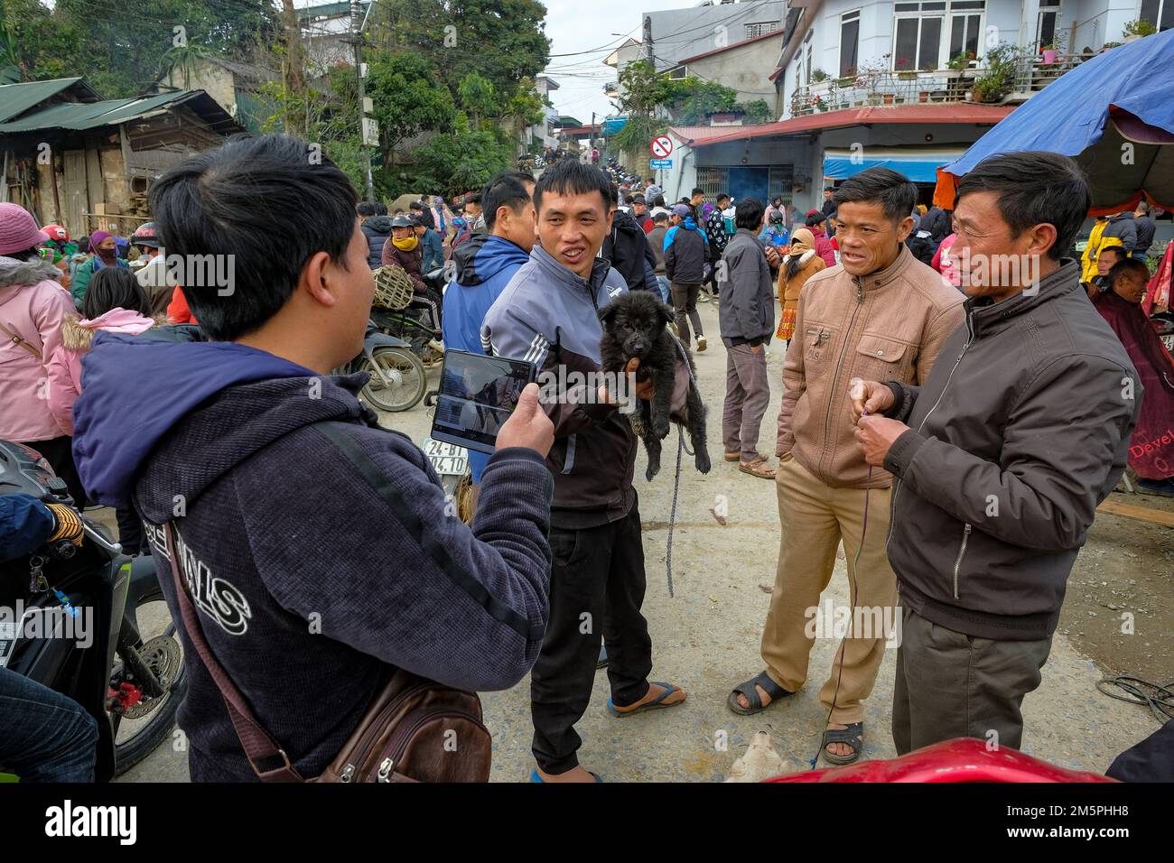 Bac Ha, Vietnam December 18, 2022 A man selling dogs at the Bac Ha