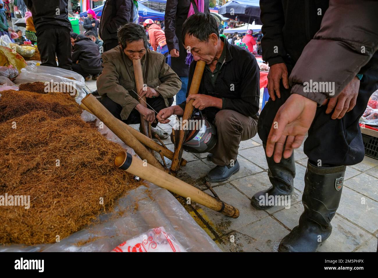 Bac Ha, Vietnam - December 18, 2022: Men smoking tobacco at the Bac Ha ...