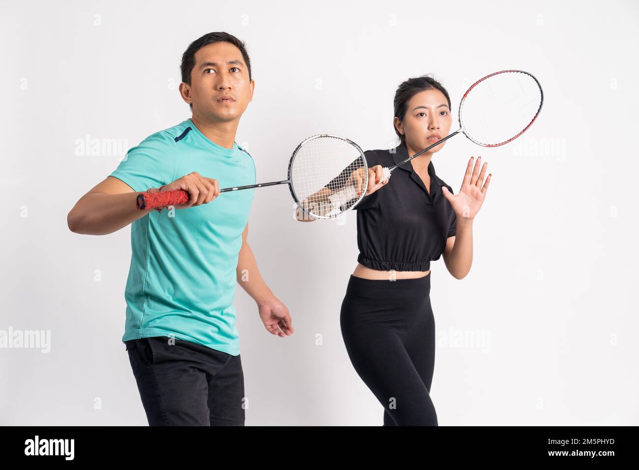 asian man and woman holding racket in ready for shuttle Stock Photo