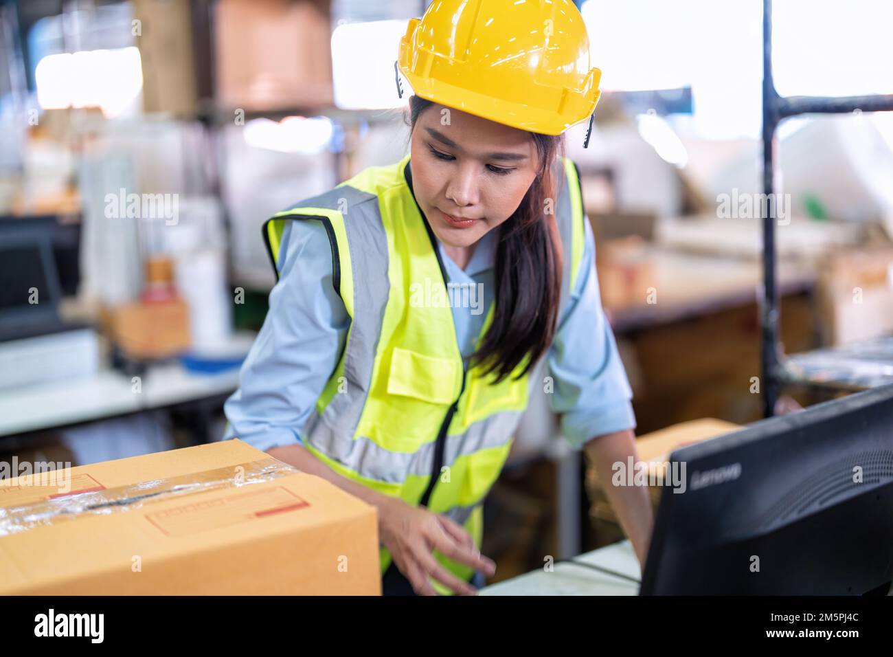 Worker working in the large depot storage warehouse happy smiling ...