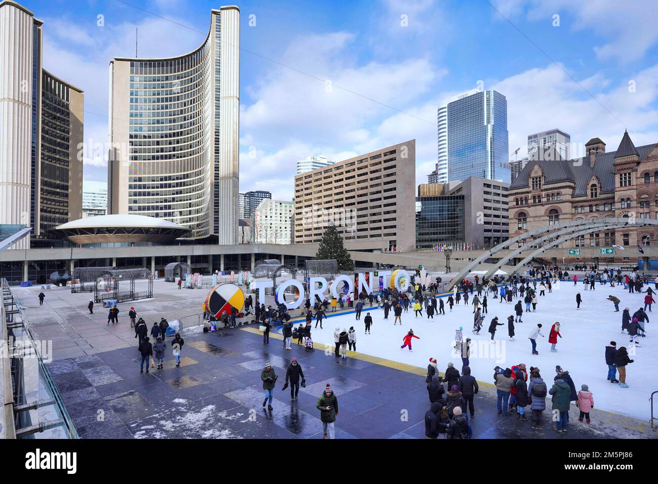 Toronto, Canada - December 2022:  The free skating rink at City Hall square is a popular attraction, with skate rentals available. Stock Photo