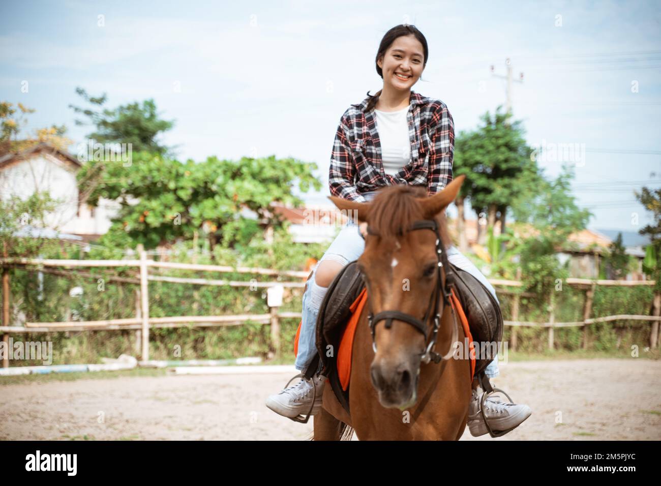 beautiful cowboy girl riding a horse while going Stock Photo