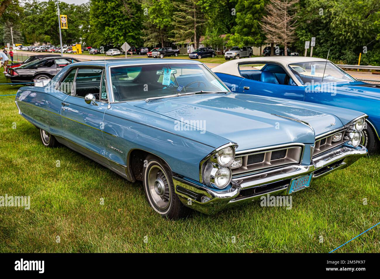 Iola, WI - July 07, 2022: High perspective front corner view of a 1965 Pontiac Grand Prix Hardtop Coupe at a local car show. Stock Photo
