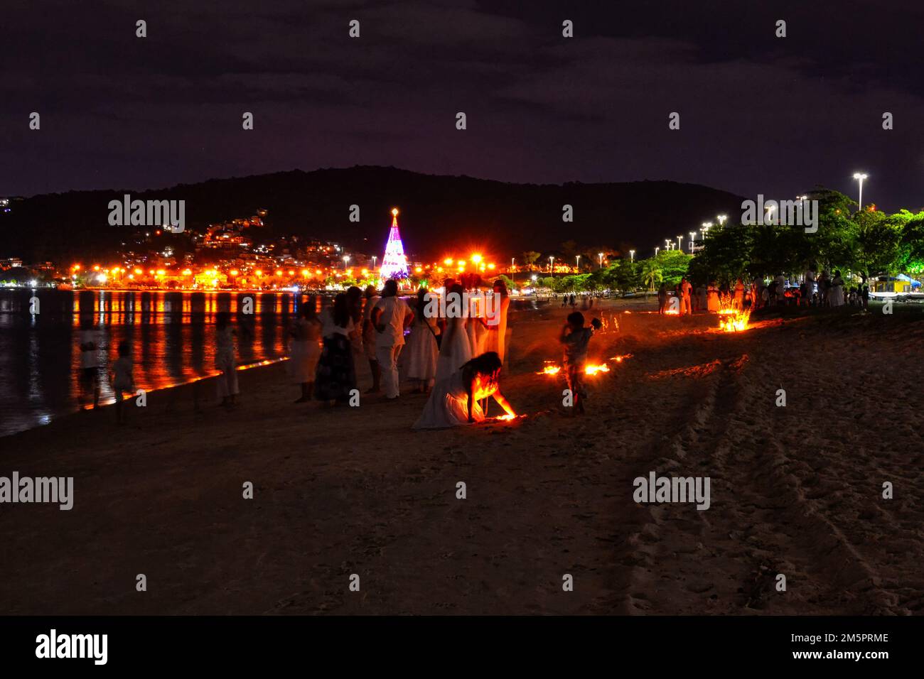 Umbanda religion. A group of people hold a candlelight vigil in the San Francisco beach. Umbanda is a syncretic Afro-Brazilian religion. Stock Photo