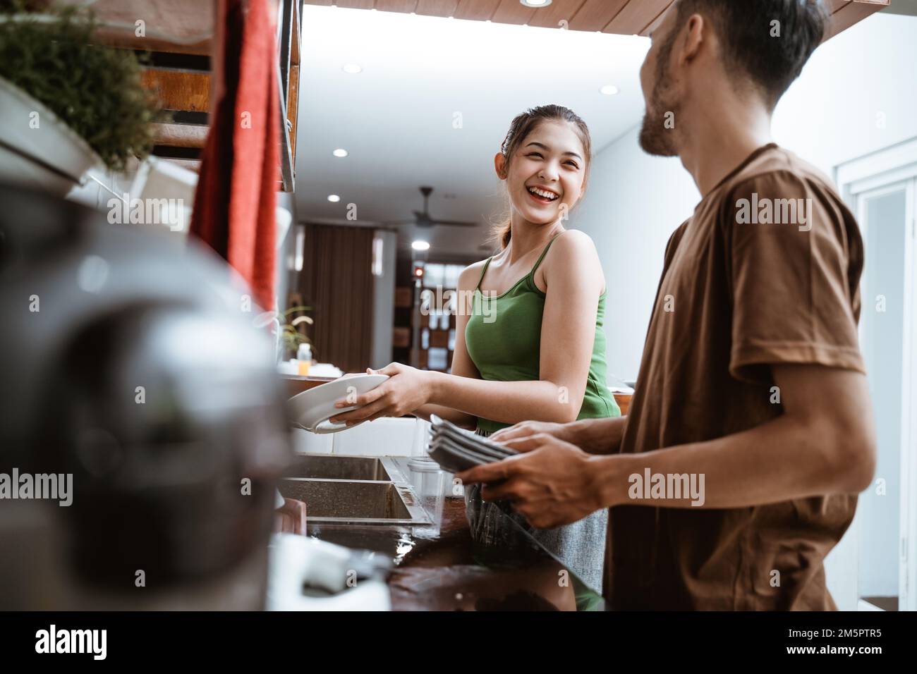 bottom view of beautiful asian women laughing while washing dishes Stock Photo
