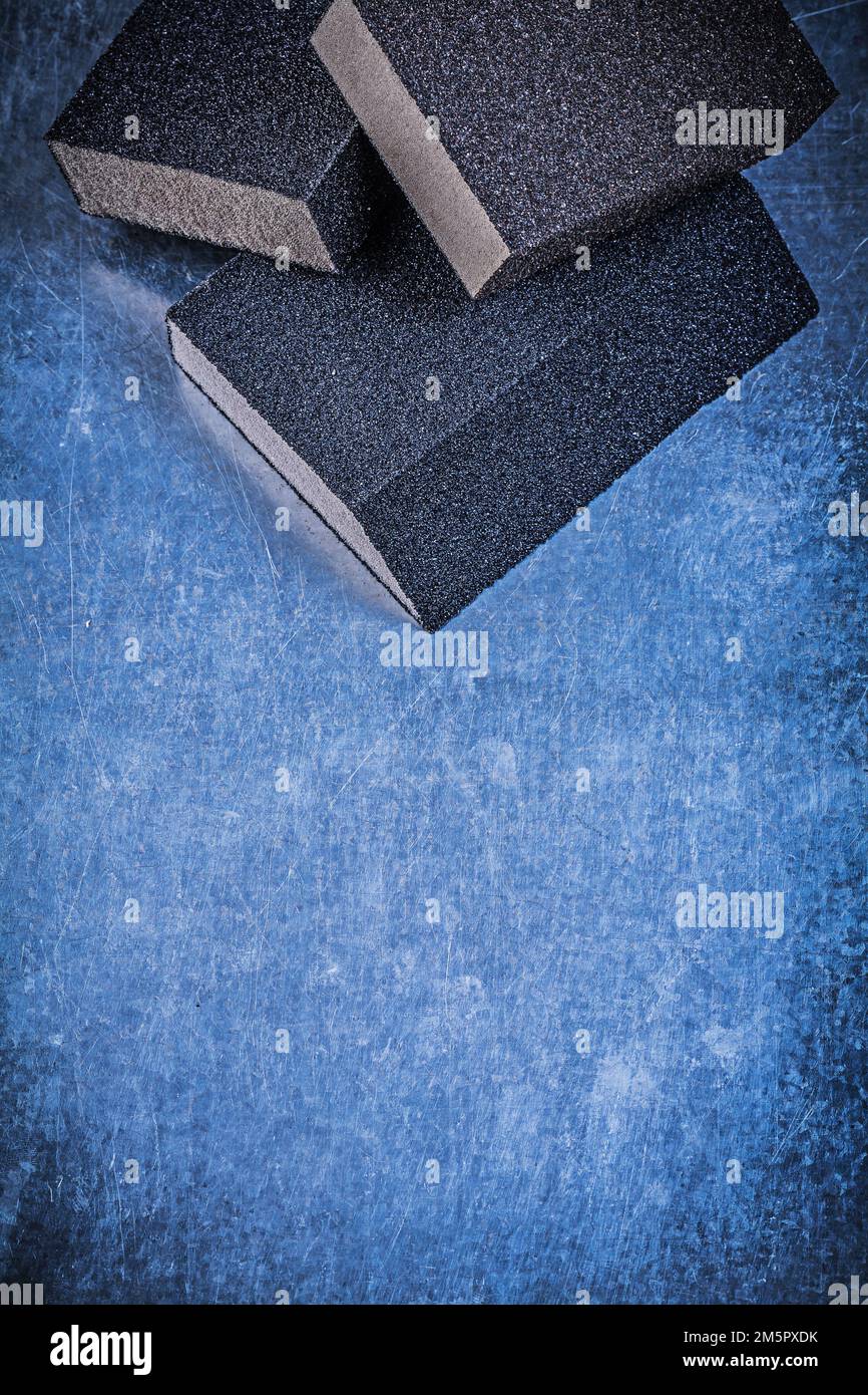 Sanding sponges on scratched metallic background abrasive materials