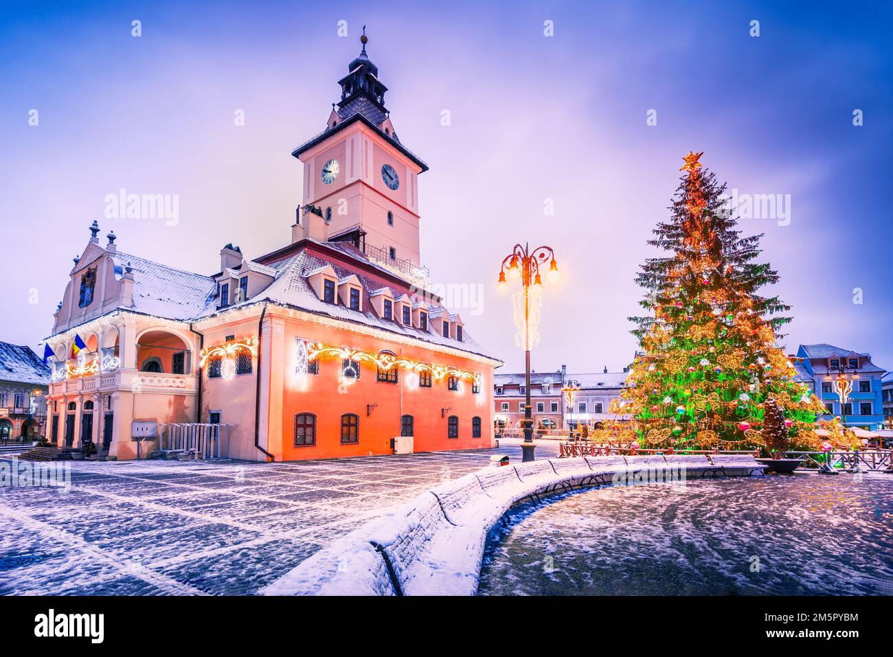Brasov, Romania. Beautiful snowy scenic Main Square with Christmas Tree, winter holidays in Transylvania. Stock Photo