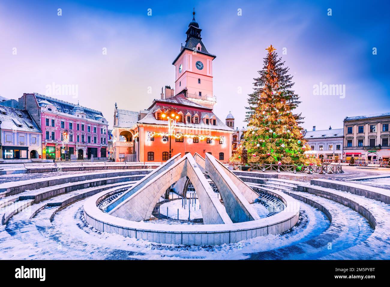 Brasov, Romania. Snowy scenic Main Square with Christmas Tree, winter holidays. Stock Photo