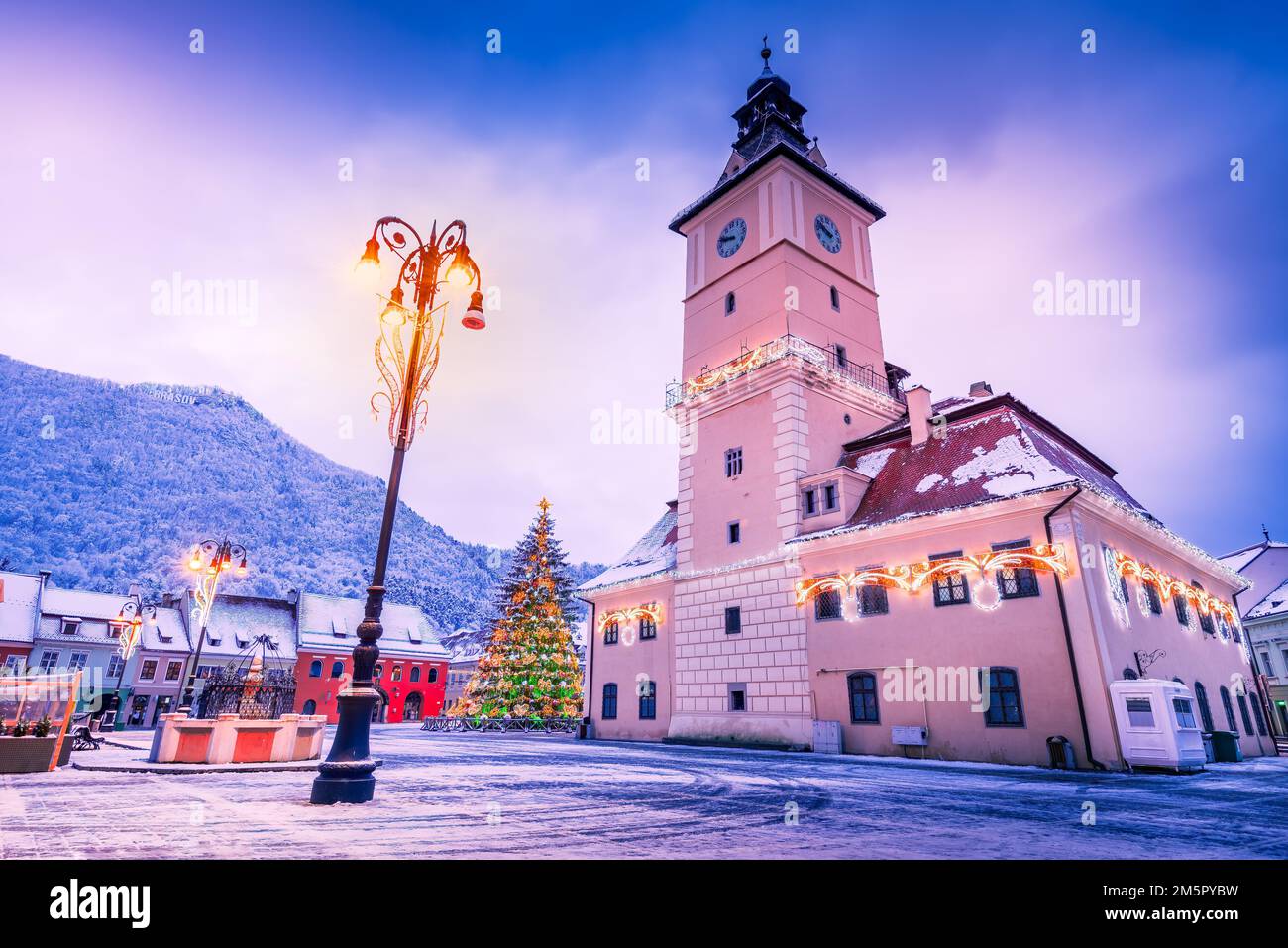 Brasov, Romania. Snowy scenic Main Square with Christmas Tree, winter holidays. Stock Photo