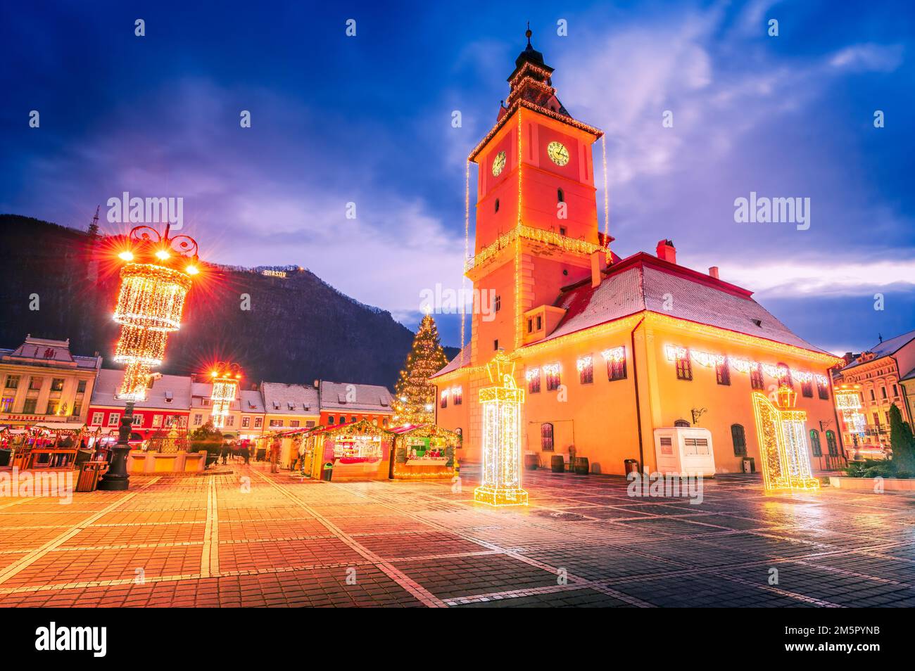 Brasov, Romania. Night illuminated scenic Main Square with Christmas Market, winter holidays. Stock Photo