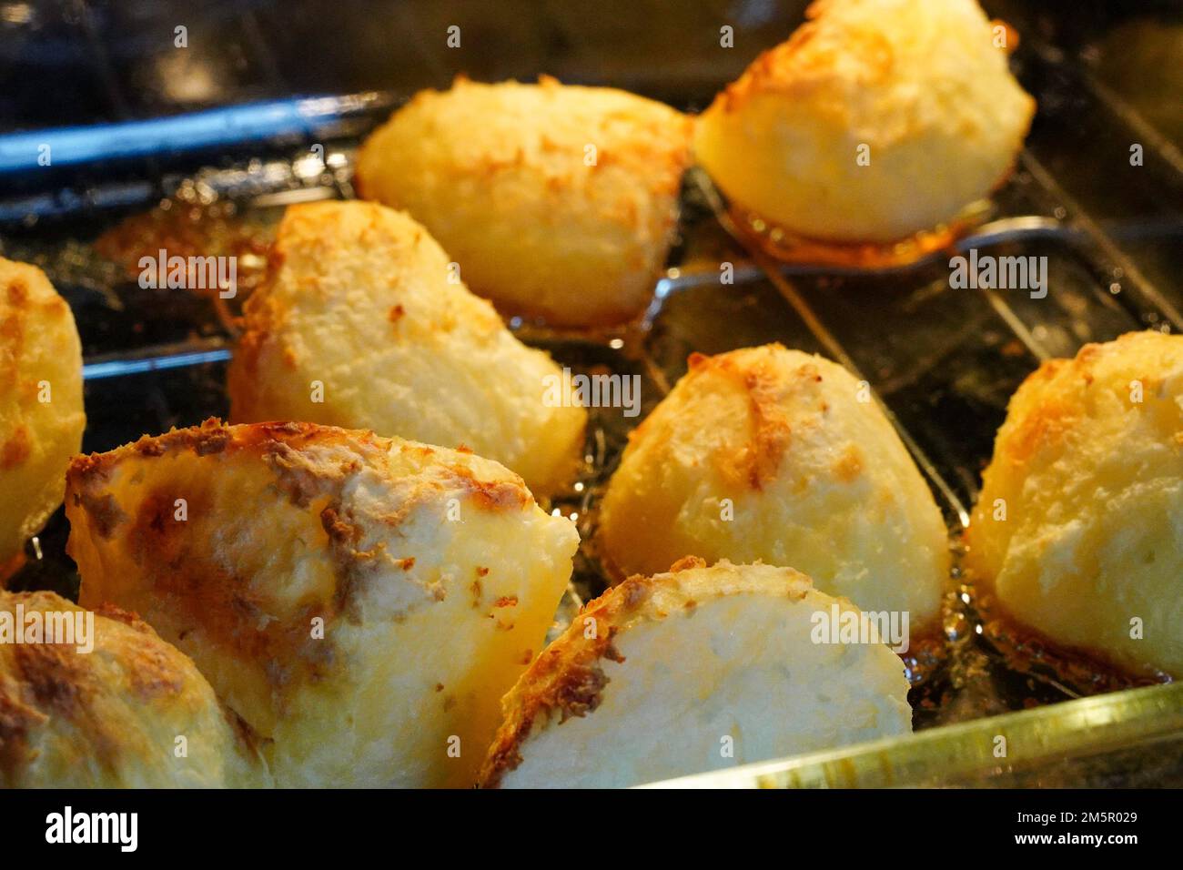 Golden potatoes cooking, roasting in the oven in goose fat Stock Photo