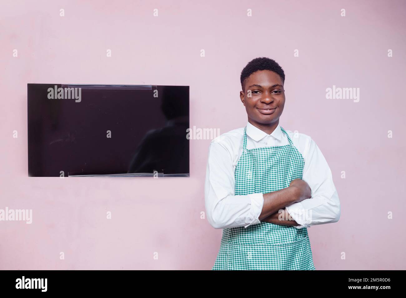 Smiling assistant wearing apron hi-res stock photography and images - Alamy