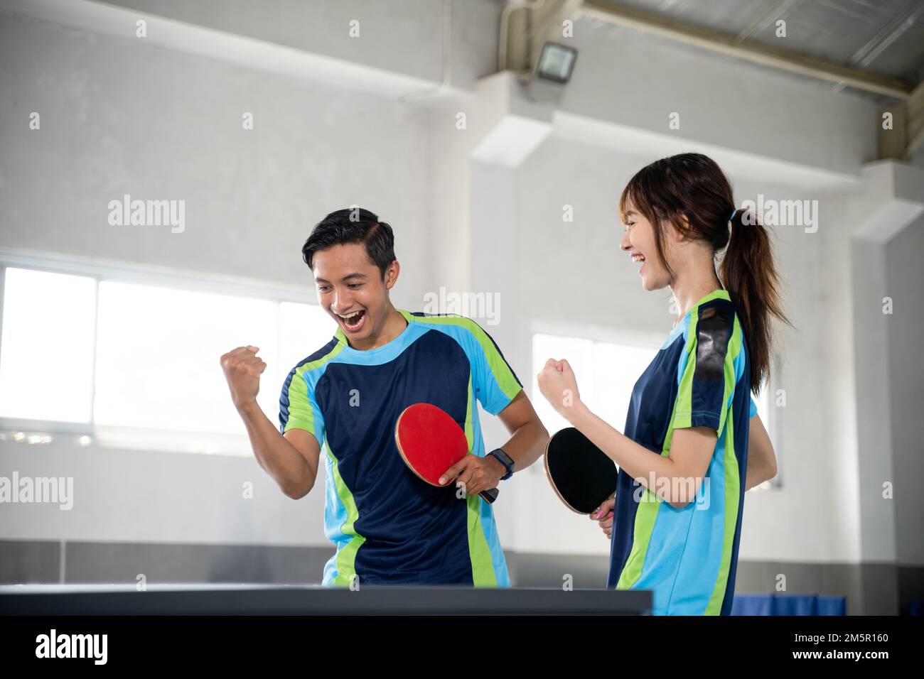 Two ping pong players compete with fists while scoring Stock Photo Alamy