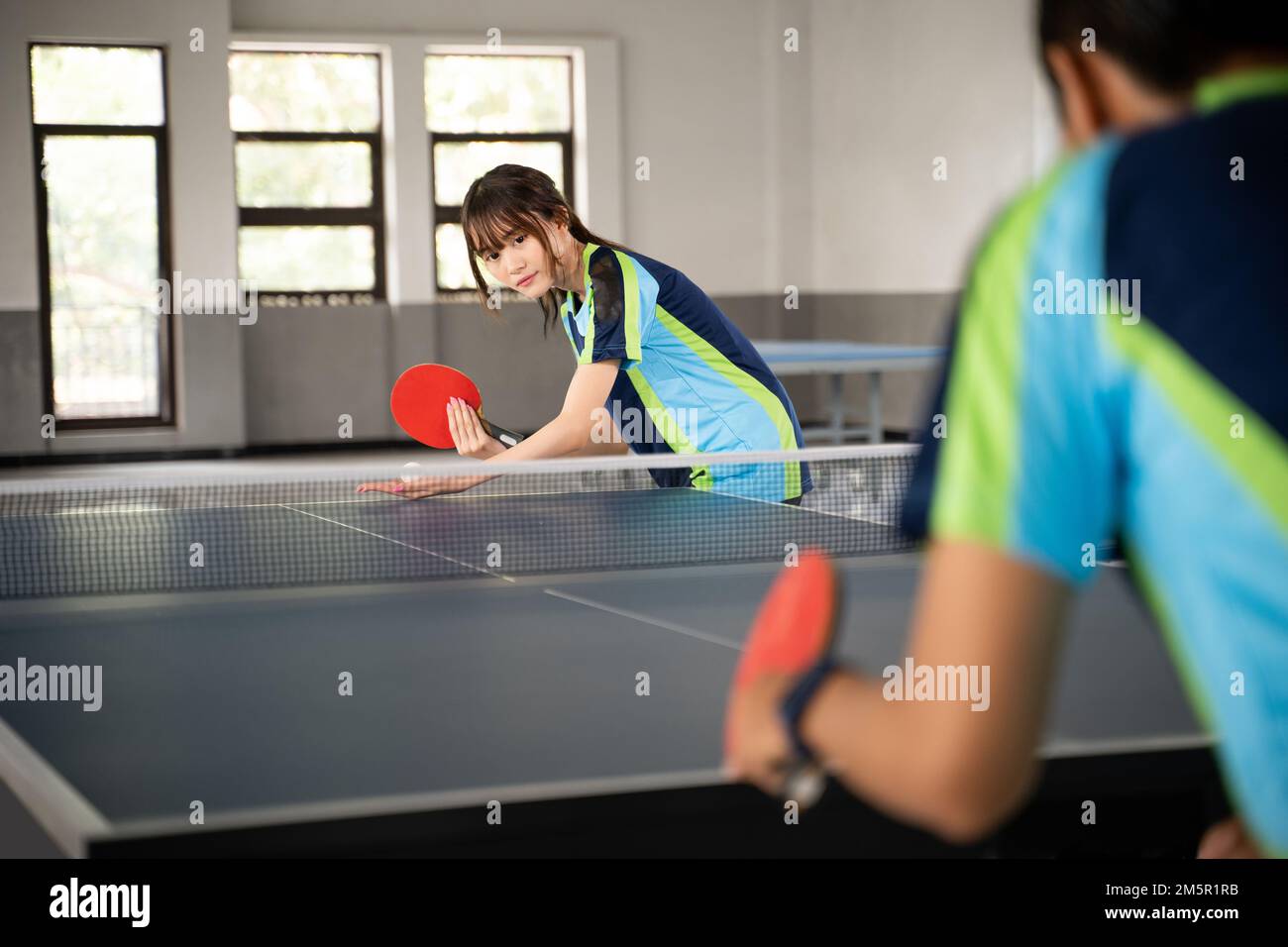 young woman facing opponent during ping pong Stock Photo