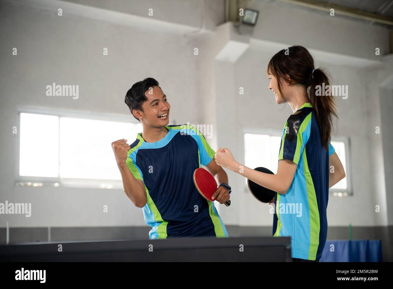 Two ping pong players compete excitedly when they score points Stock