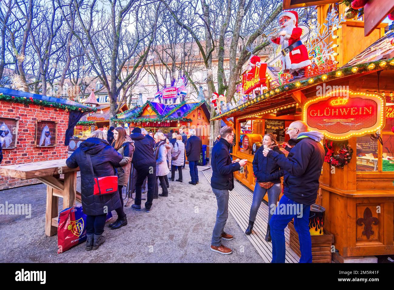 Basel, Switzerland - December 2017. Basler Weihnachtsmarkt, Christmas Market Munsterplatz, Basel with traditional glue wine wooden chalets. Stock Photo