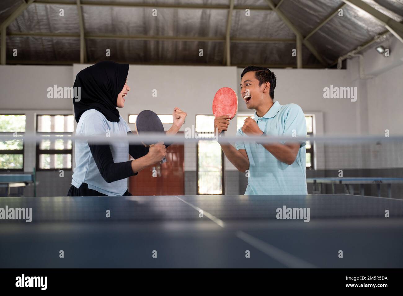 mixed doubles ping pong athlete excited to win Stock Photo