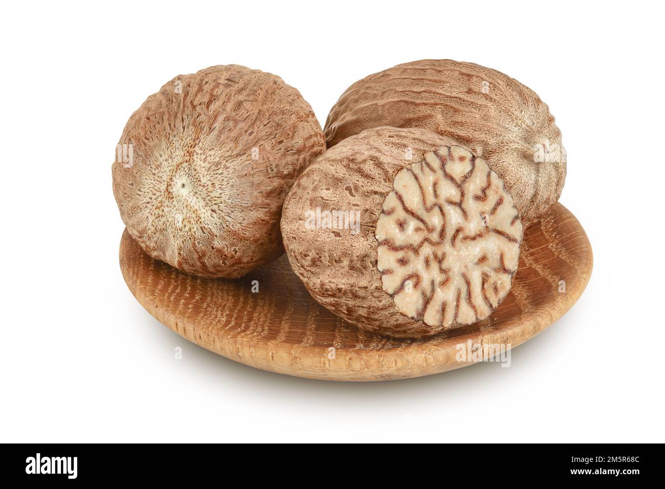 Nutmeg In Wooden Bowl Isolated On White Background With Full Depth Of