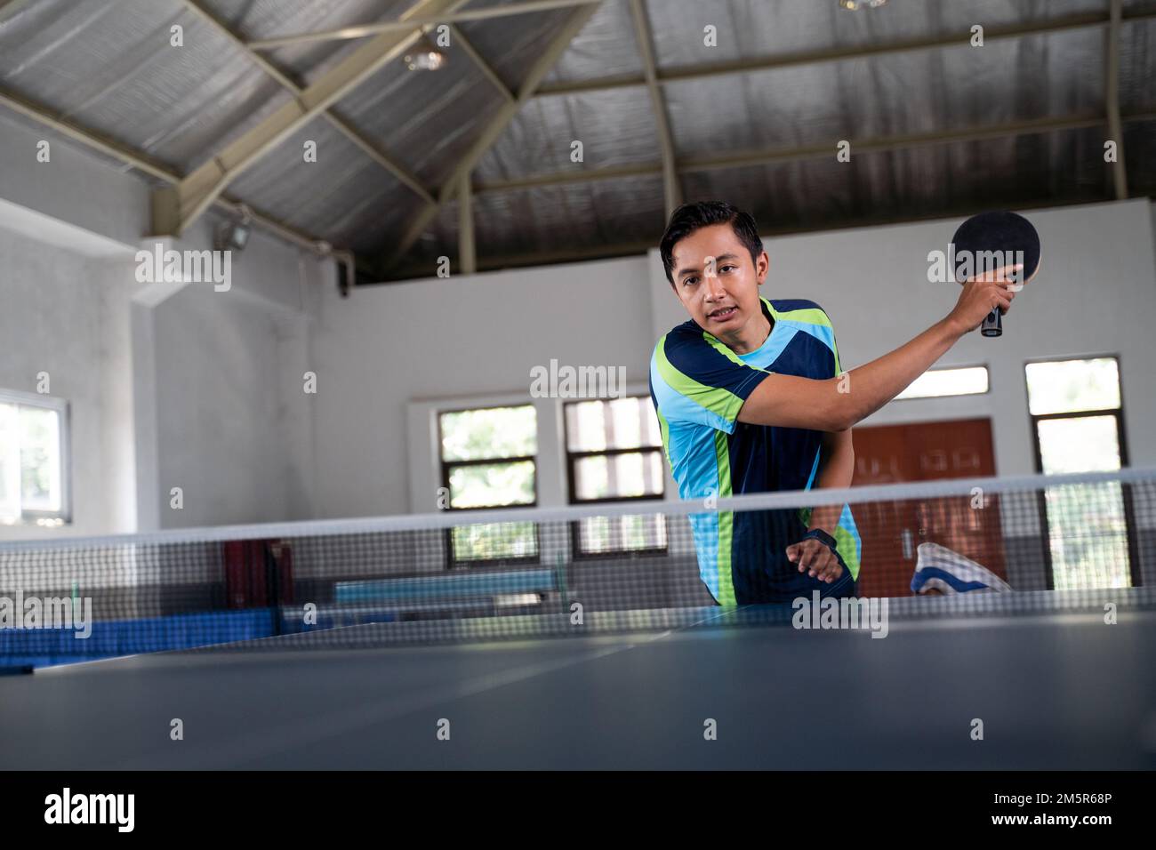 male ping pong athlete hitting smash in ping pong match Stock Photo - Alamy