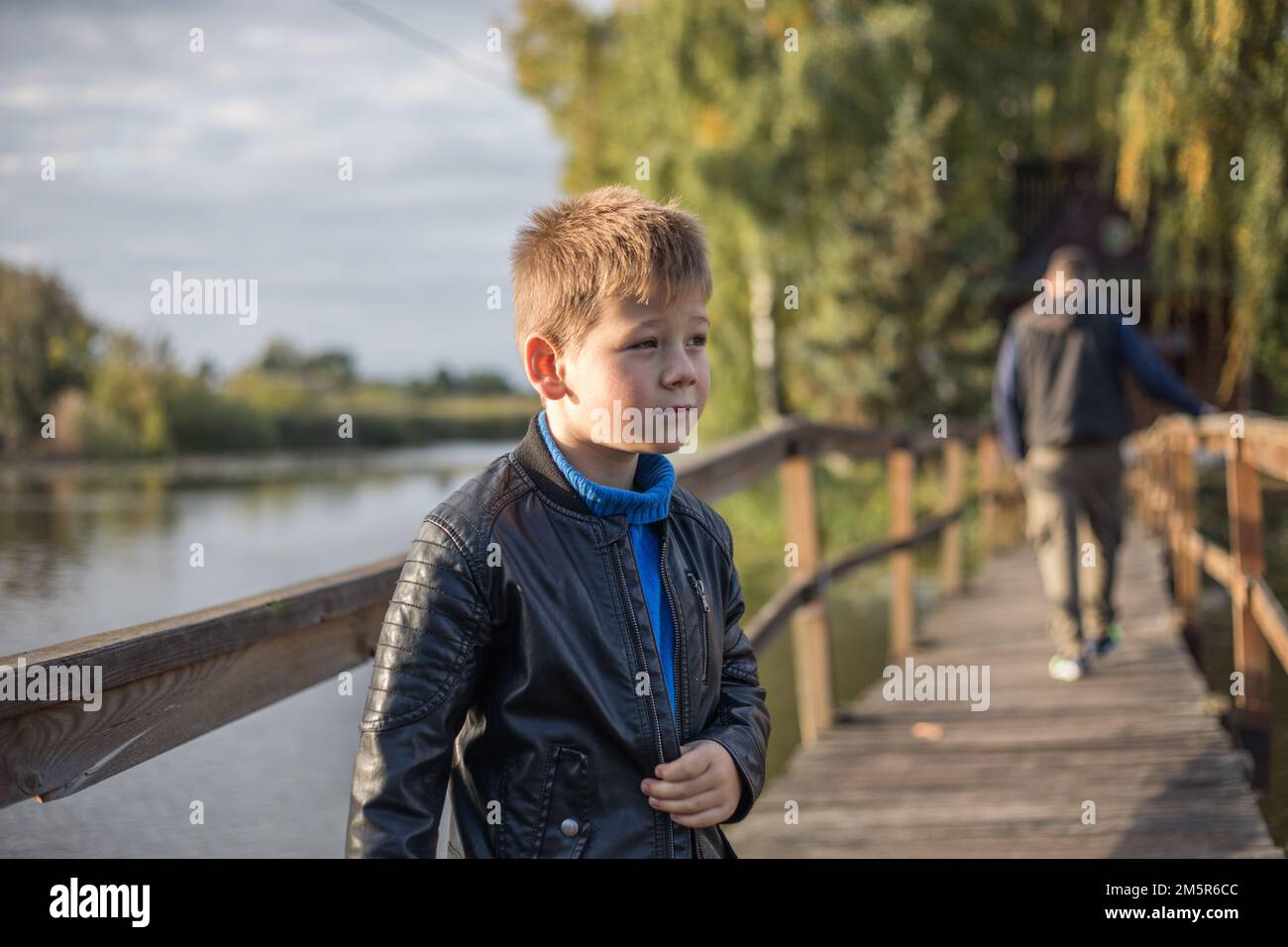 Handsome boy looks sad and little boy has to stay alone because his dad