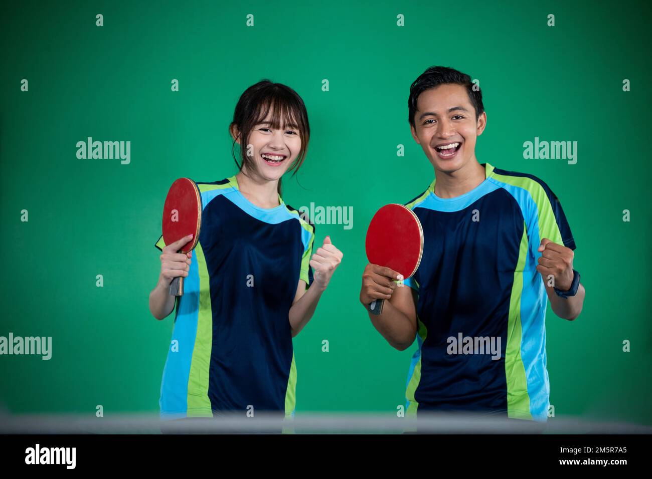 Asian male and female players with fists Stock Photo