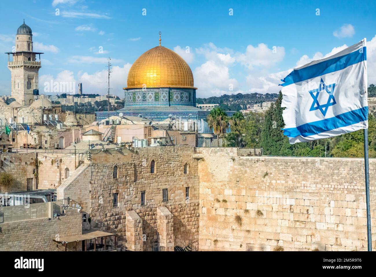 An Israeli flag blows as jewish orthodox believers read the Torah and ...