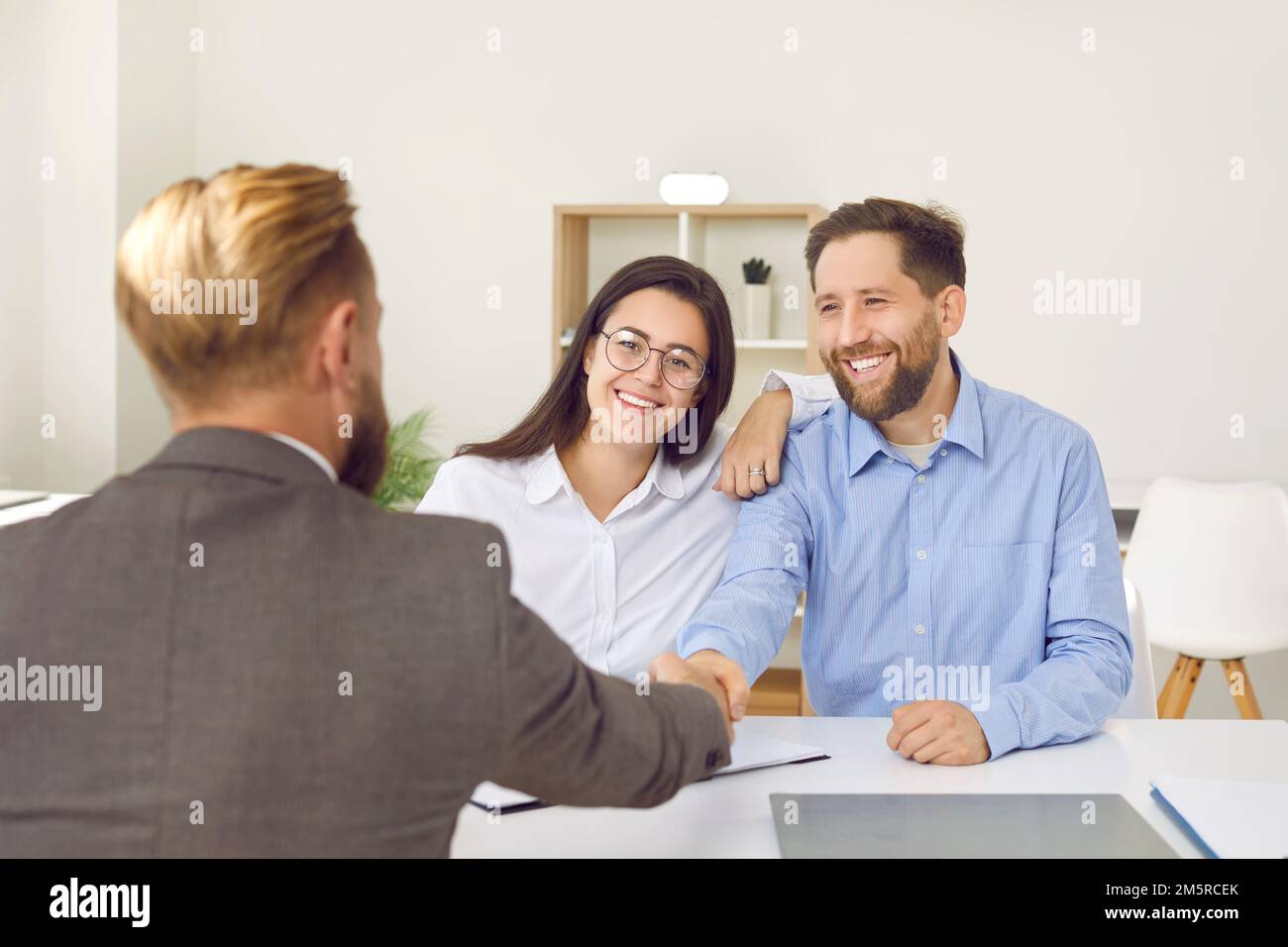 Family couple handshaking with bank manager, lawyer, real estate agent, lawyer Stock Photo