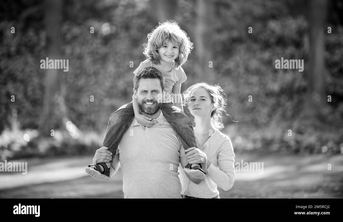 We are happy being a family of three. Happy family with boy child. Mother and kid riding piggy back on father. Its really wonderful, parenting. Stock Photo