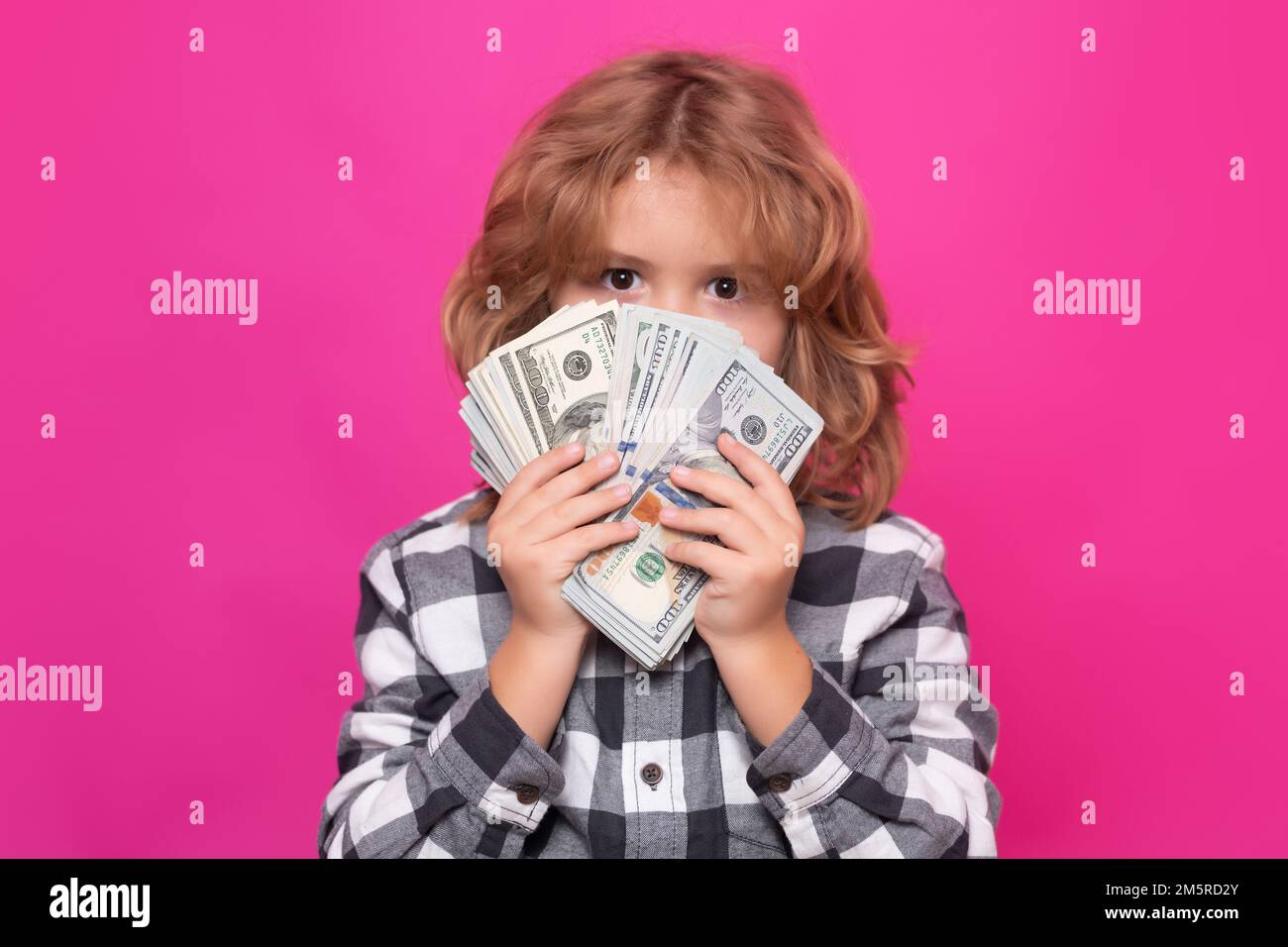 Rich kid with dollars. Lottery cashback, win big money isolated pink red background. Stock Photo