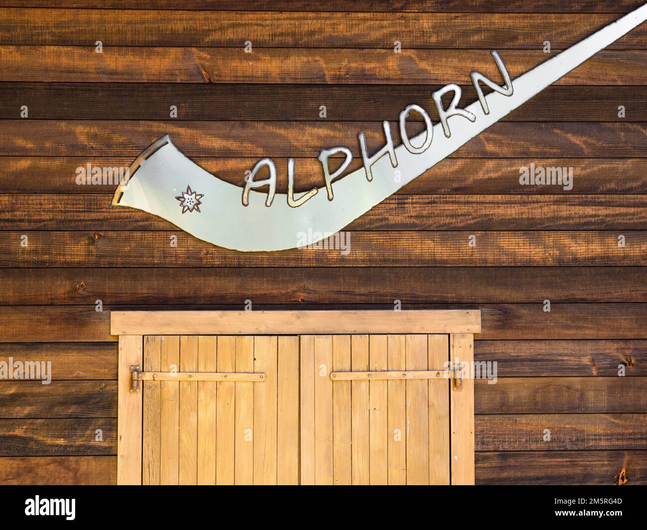 Bettmeralp, Switzerland - July 16, 2022: Instrument alphorn or alpenhorn or alpine horn is a labrophone, consisting of a straight several meter long w Stock Photo