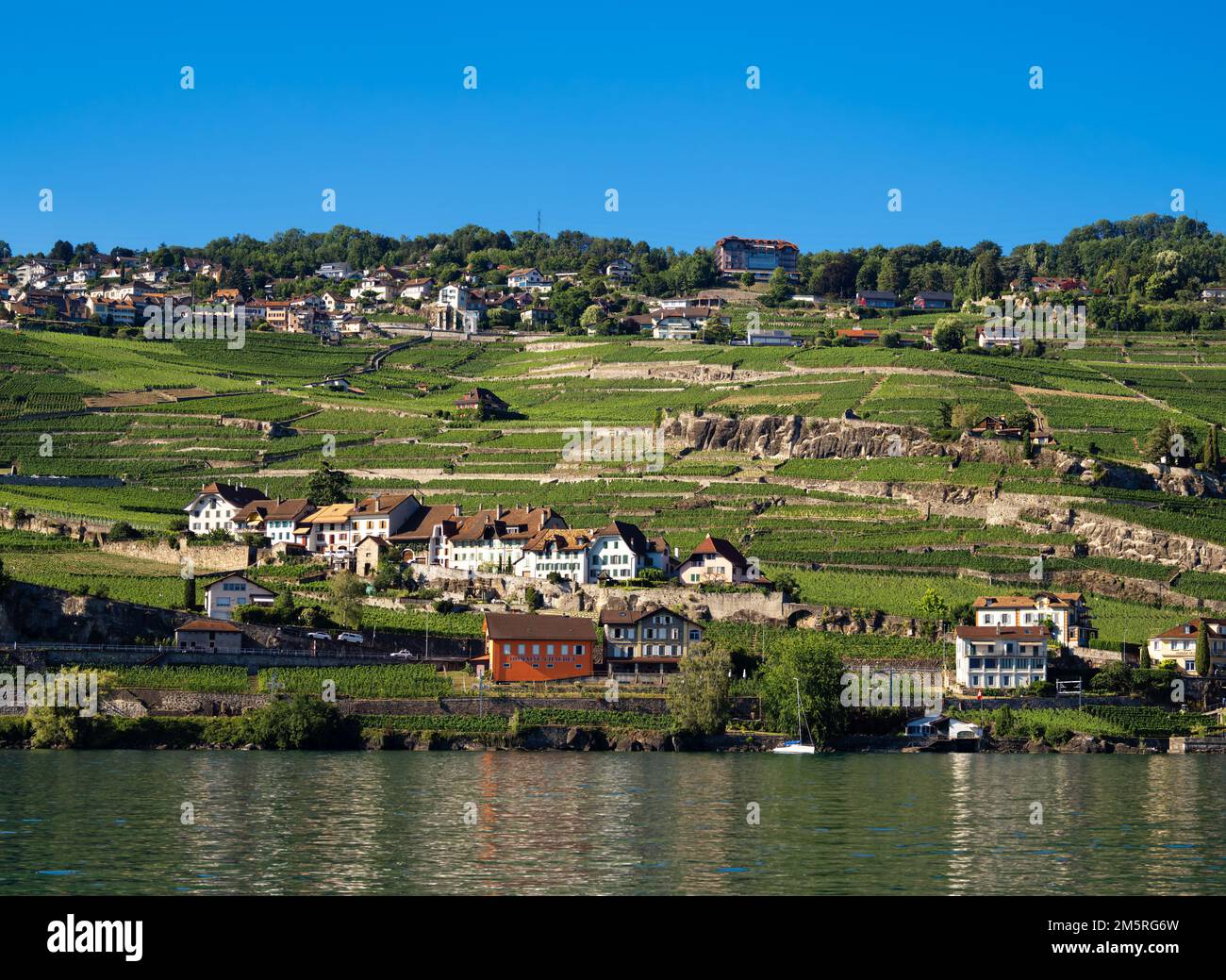 View from Lake Geneva in Switzerland at the village of Rivaz and the Lavaux vineyard terraces - Unesco Heritage Stock Photo