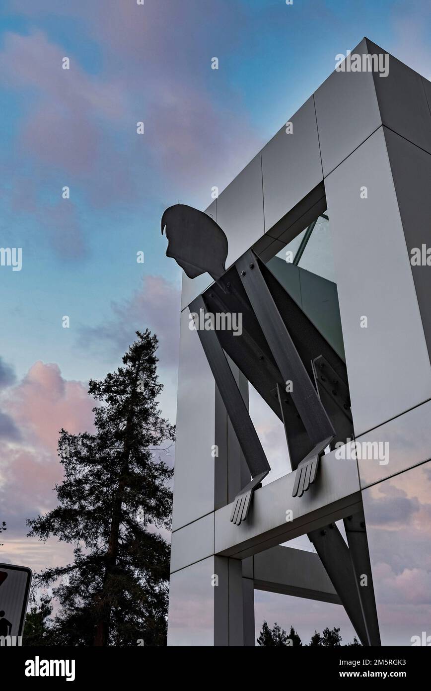 Large human statue with modern architecture in google campus during sunset Stock Photo